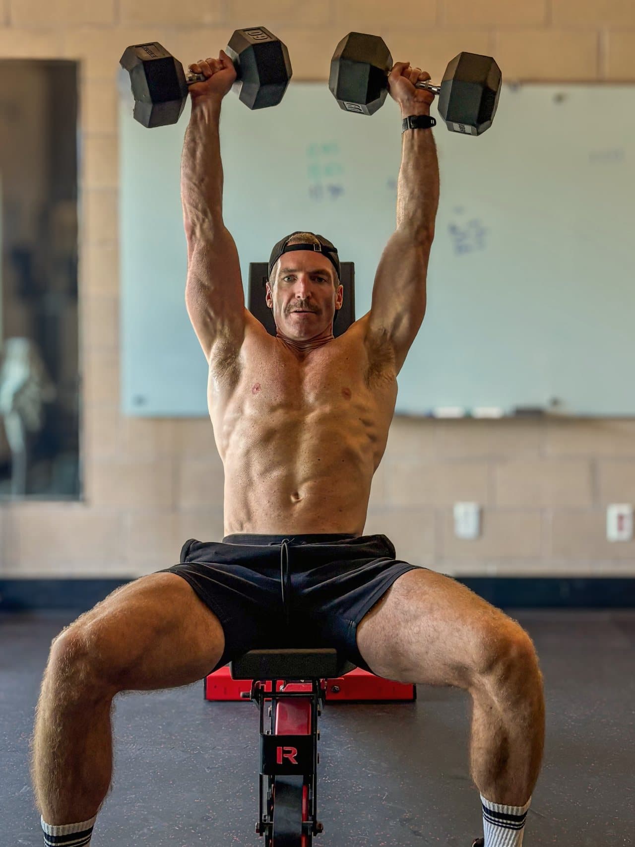 Matt, IronShift founder, mid set of seated dumbbell presses